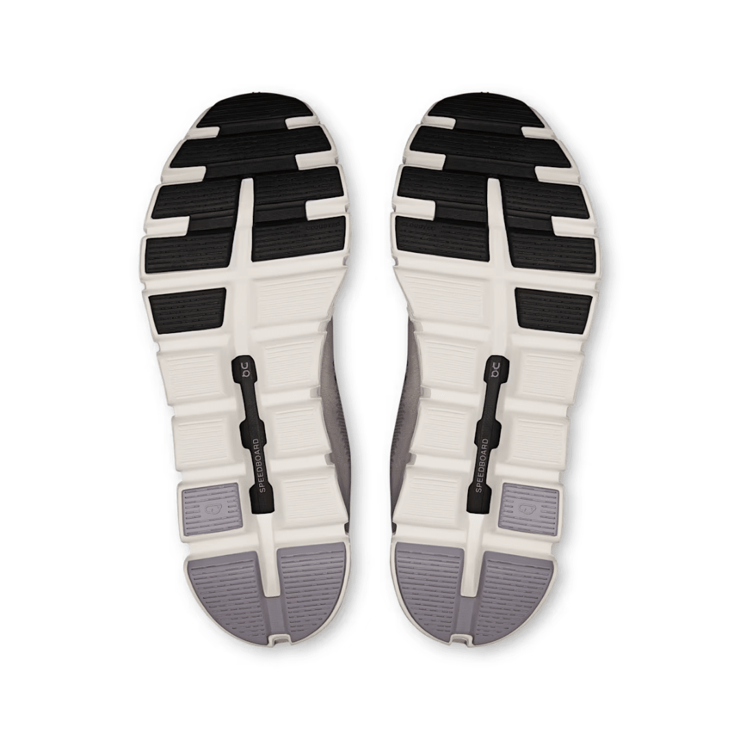 Top view of a pair of shoes with a white sole and black and gray accents on a white background