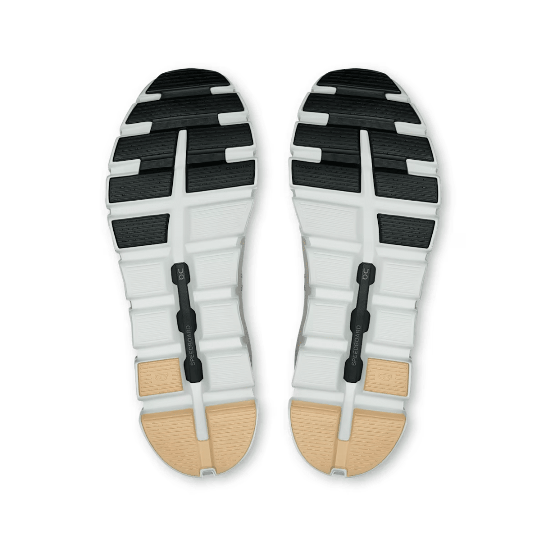 Top view of a sandal with white sole, black straps, and wooden heel