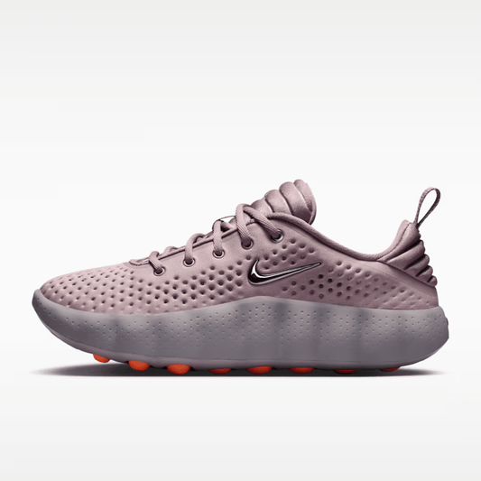 Pink sneaker with a Nike logo on a white background
