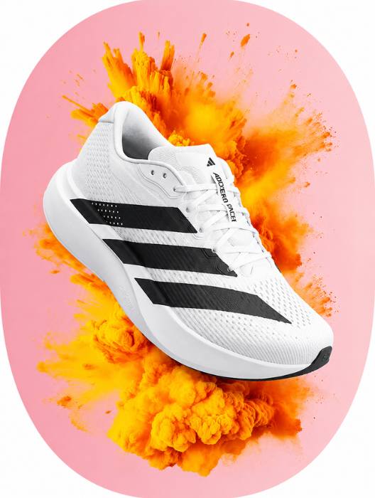 White Adidas shoe on a pink background with orange smoke effect
