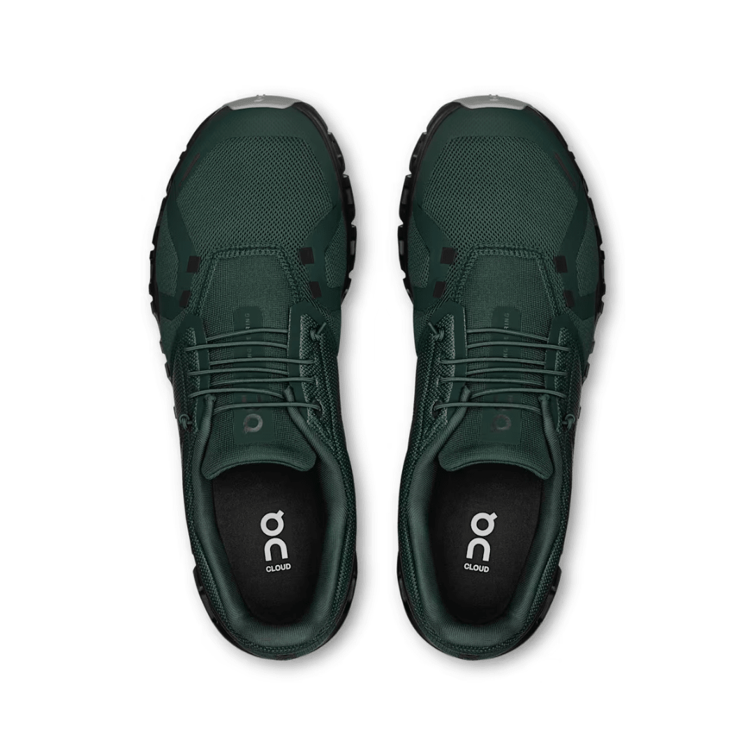 Pair of green athletic shoes with 'on' logo on a white background