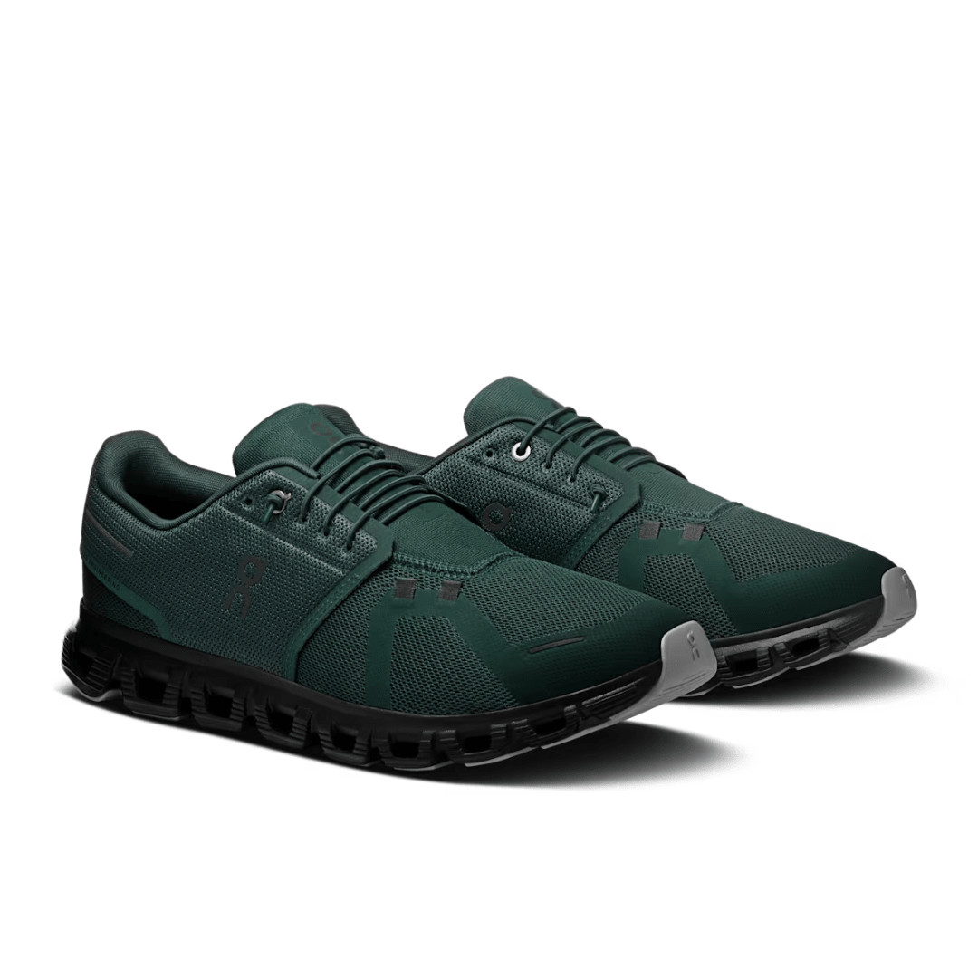 Pair of green athletic shoes on a white background