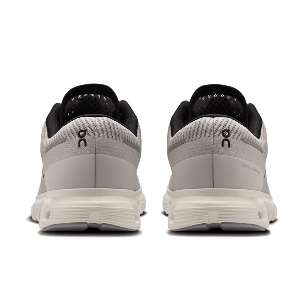 Pair of gray running shoes with black accents on a white background