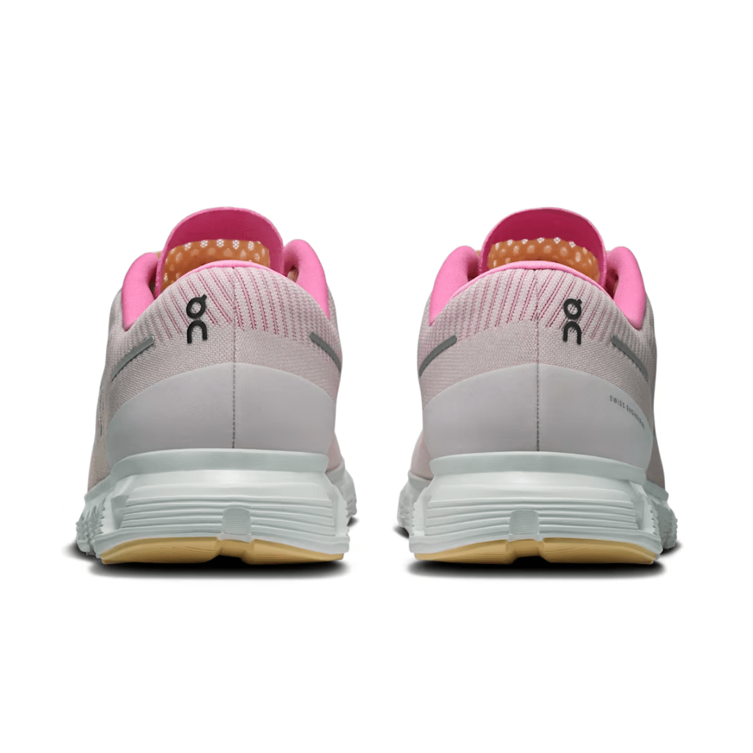 Pink and white running shoes with visible brand logo on a white background
