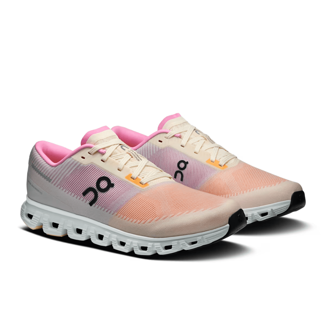 Pair of pink and beige running shoes on a white background