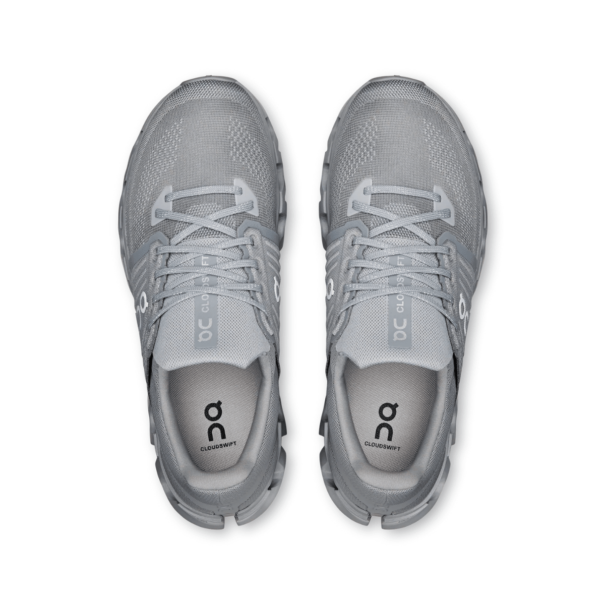 Pair of gray running shoes with 'on' branding on a white background