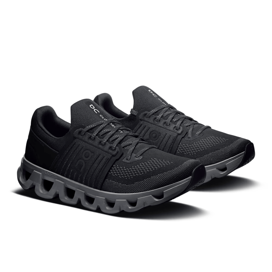Black running shoes with unique sole design on a white background