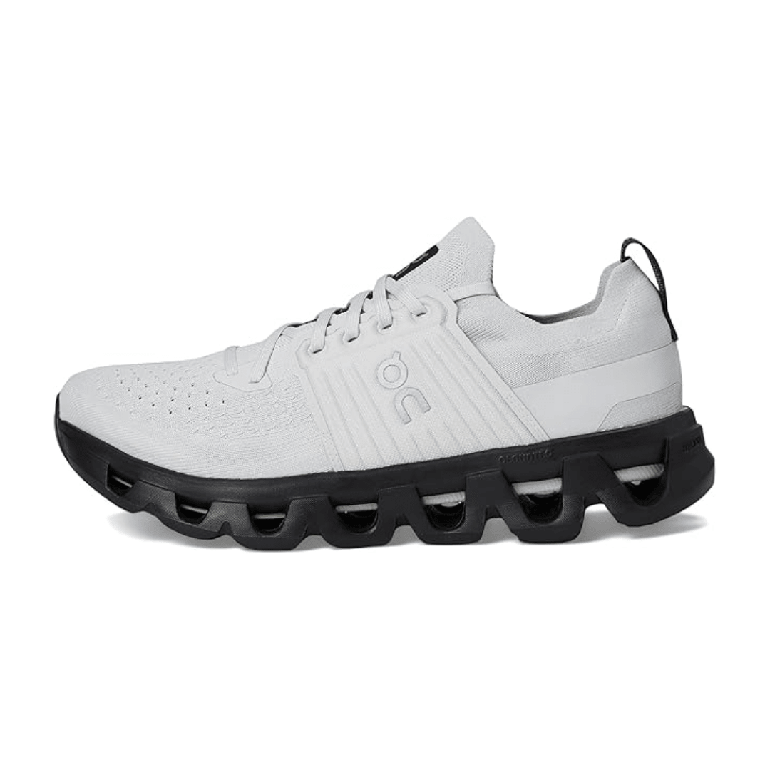 White athletic shoe with black sole on a white background