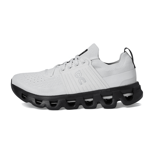 White athletic shoe with black sole on a white background