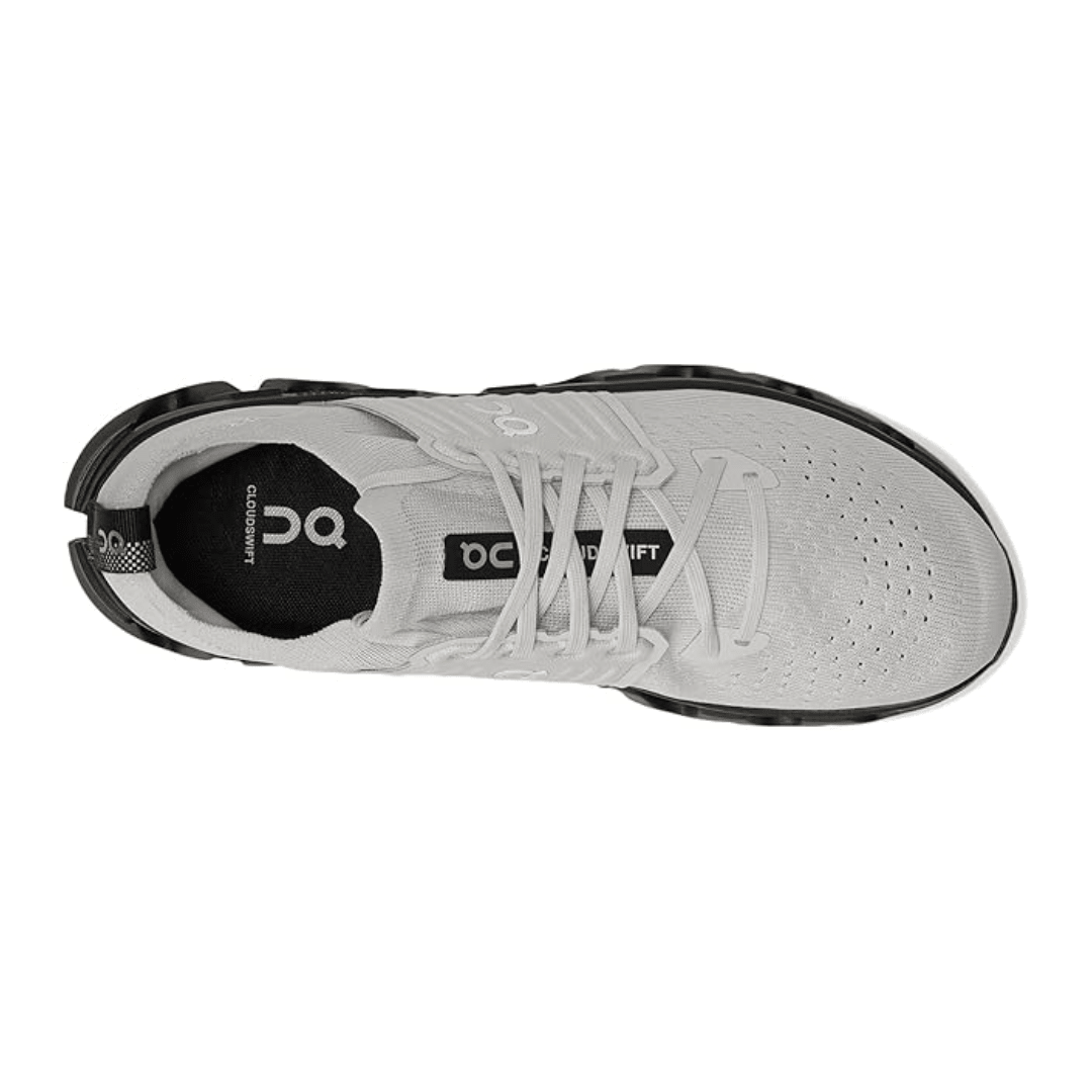 White athletic shoe with black sole on a white background