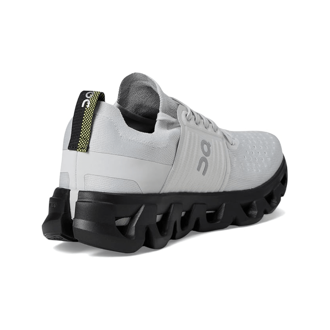 White running shoe with black sole on a white background