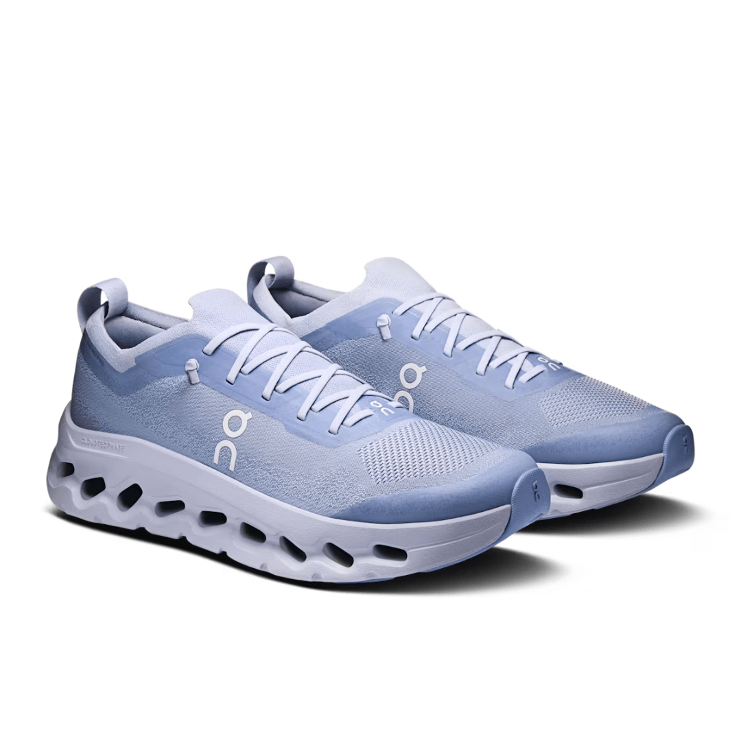 Pair of light blue running shoes on a white background