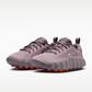 Pair of purple running shoes with orange soles on a white background