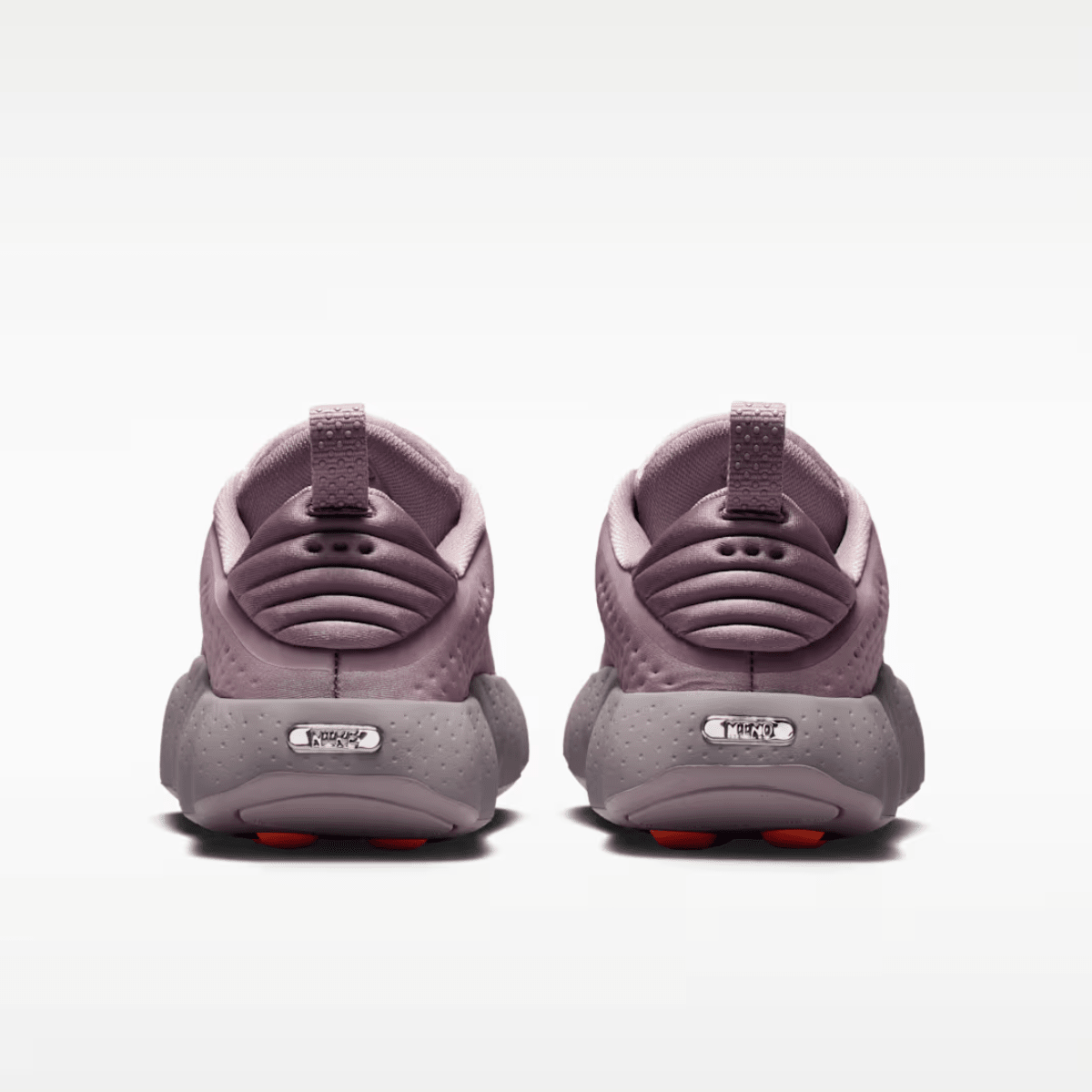 Pair of purple children's shoes on a white background