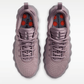 Pair of light purple sneakers with red accents on a white background