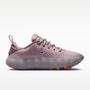 Pink running shoe with Nike logo on a white background