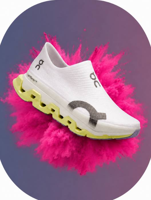 White athletic shoe with a colorful background