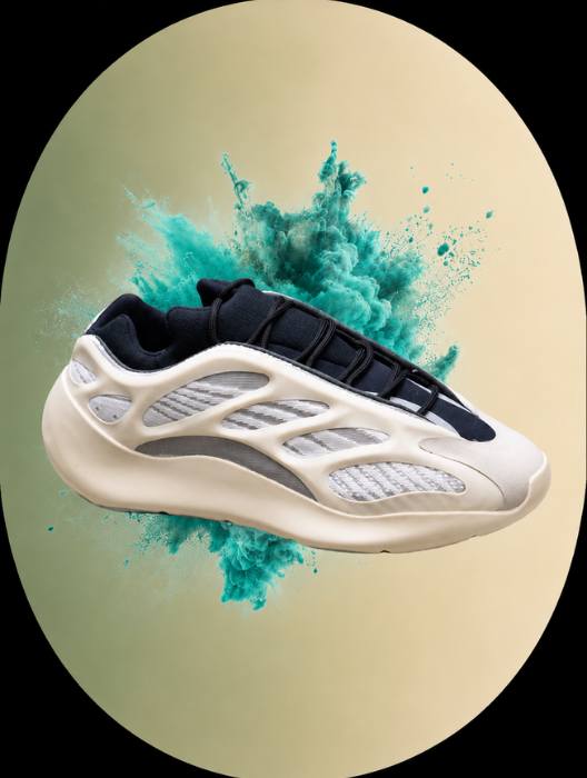 White and black sneaker with teal powder explosion on a beige background